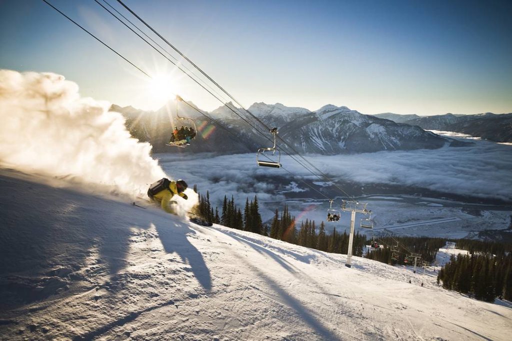 A snowboarder cuts a path down a steep vertical at Revelstoke.